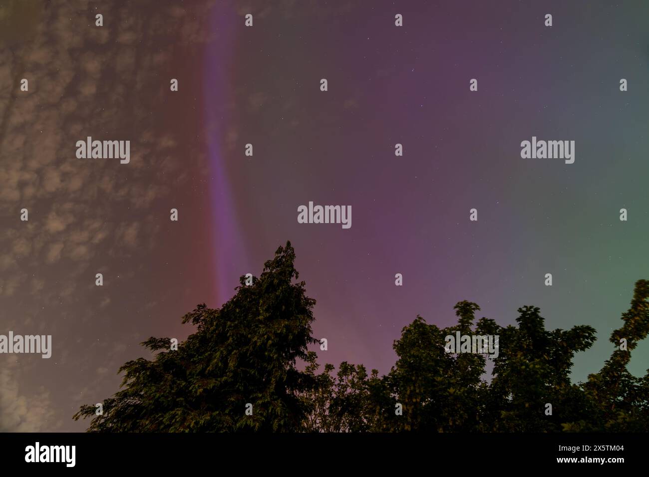 Mesmerizing aurora borealis colors stretch across the night sky above ...