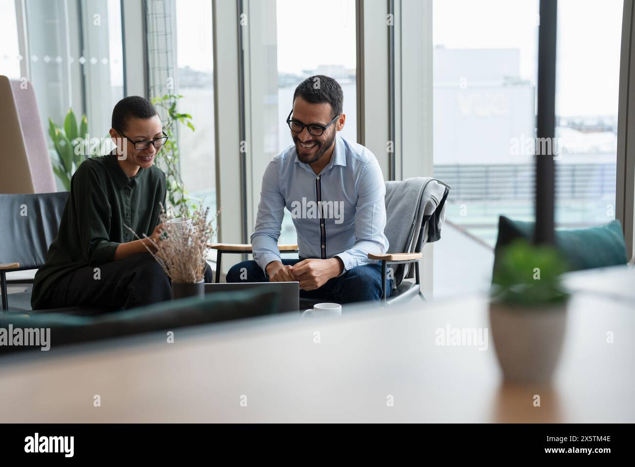 Business people having meeting in office lobby Stock Photo - Alamy
