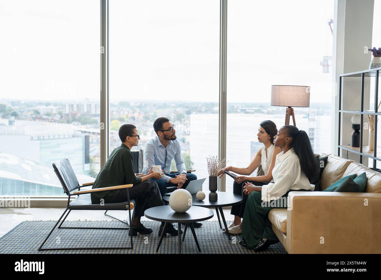 Business people having meeting in office lobby Stock Photo - Alamy