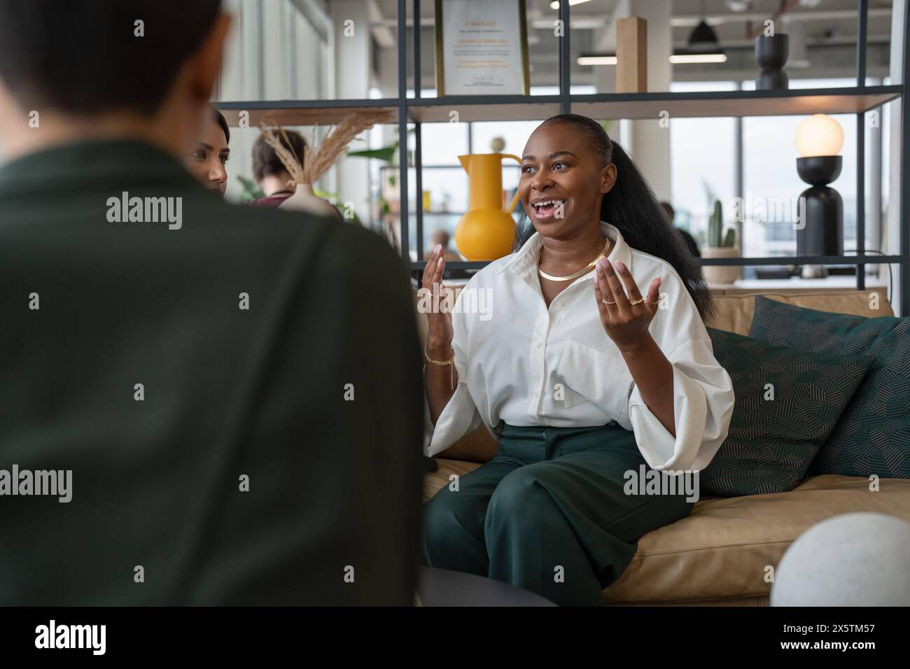 Business people having meeting in office lobby Stock Photo - Alamy