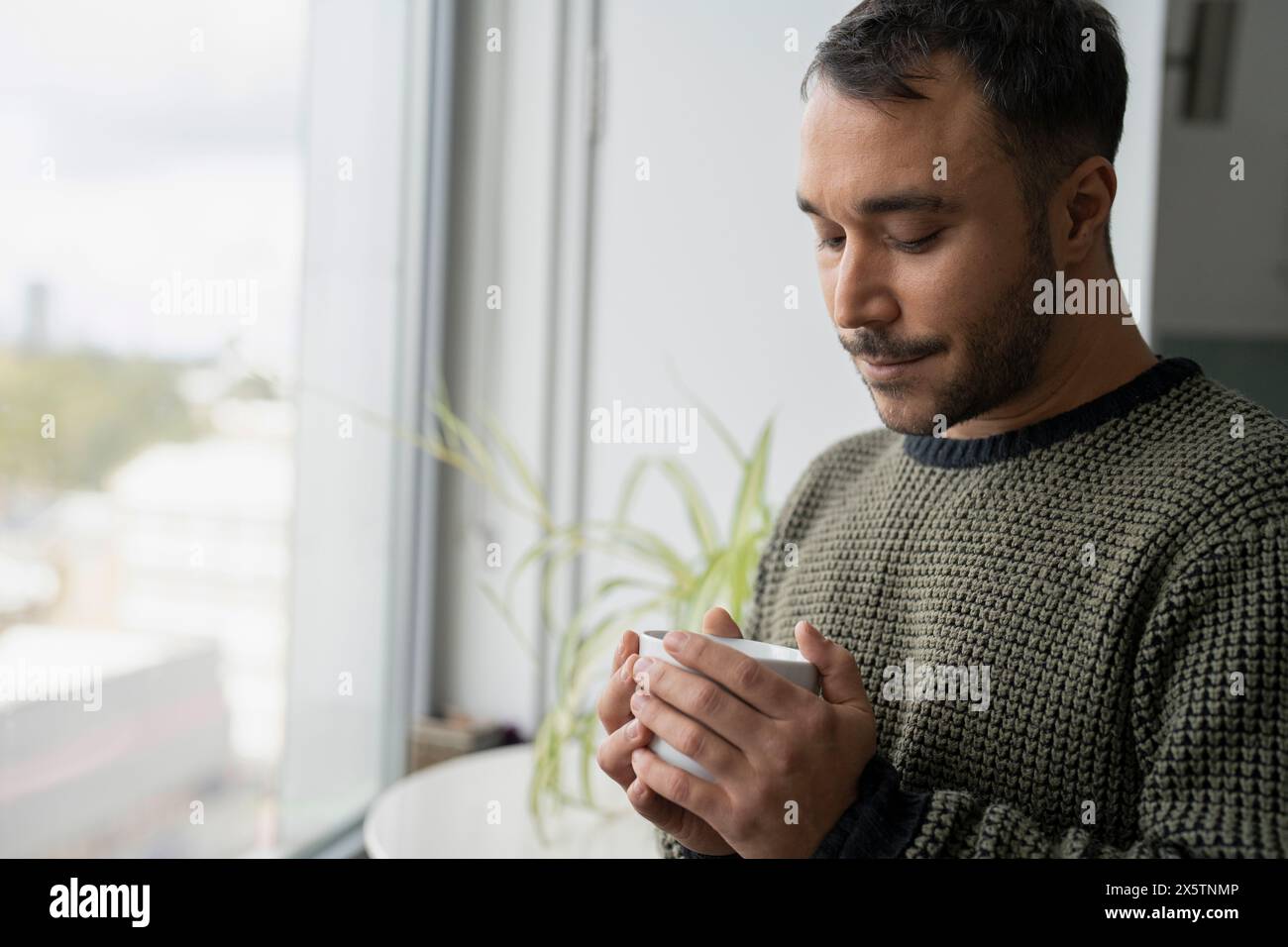 Mature man standing by window hi-res stock photography and images - Alamy
