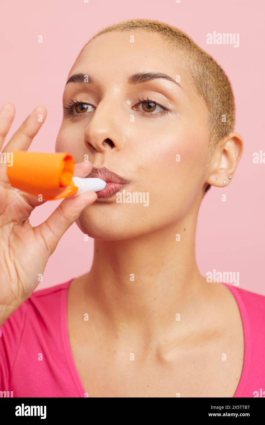 Young woman blowing party horn hi-res stock photography and images - Alamy