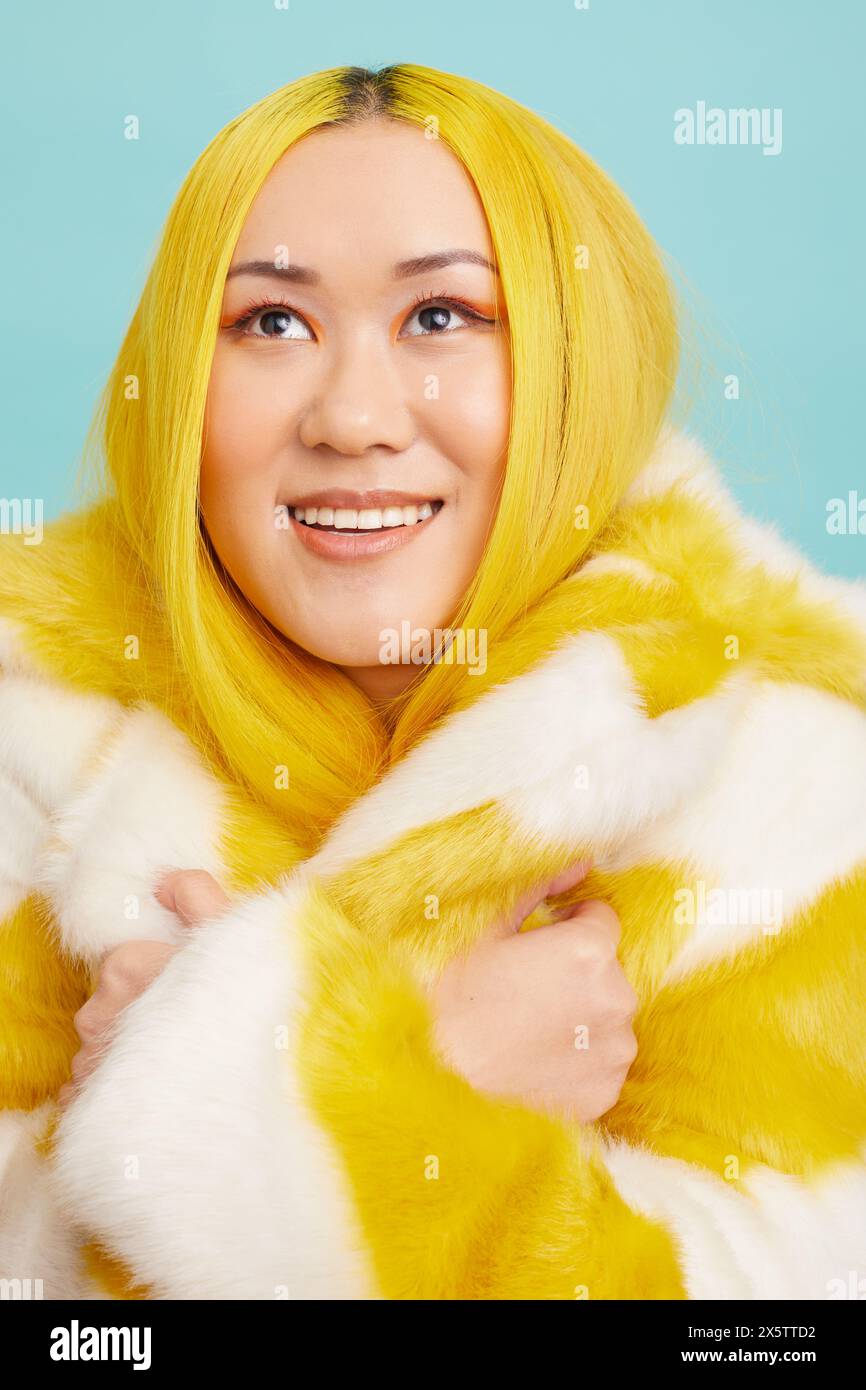 Woman with long yellow hair, wearing fur coat Stock Photo - Alamy