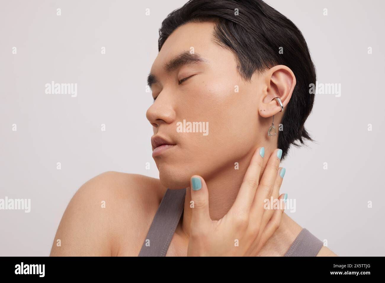 Studio portrait of handsome man with ear piercing Stock Photo
