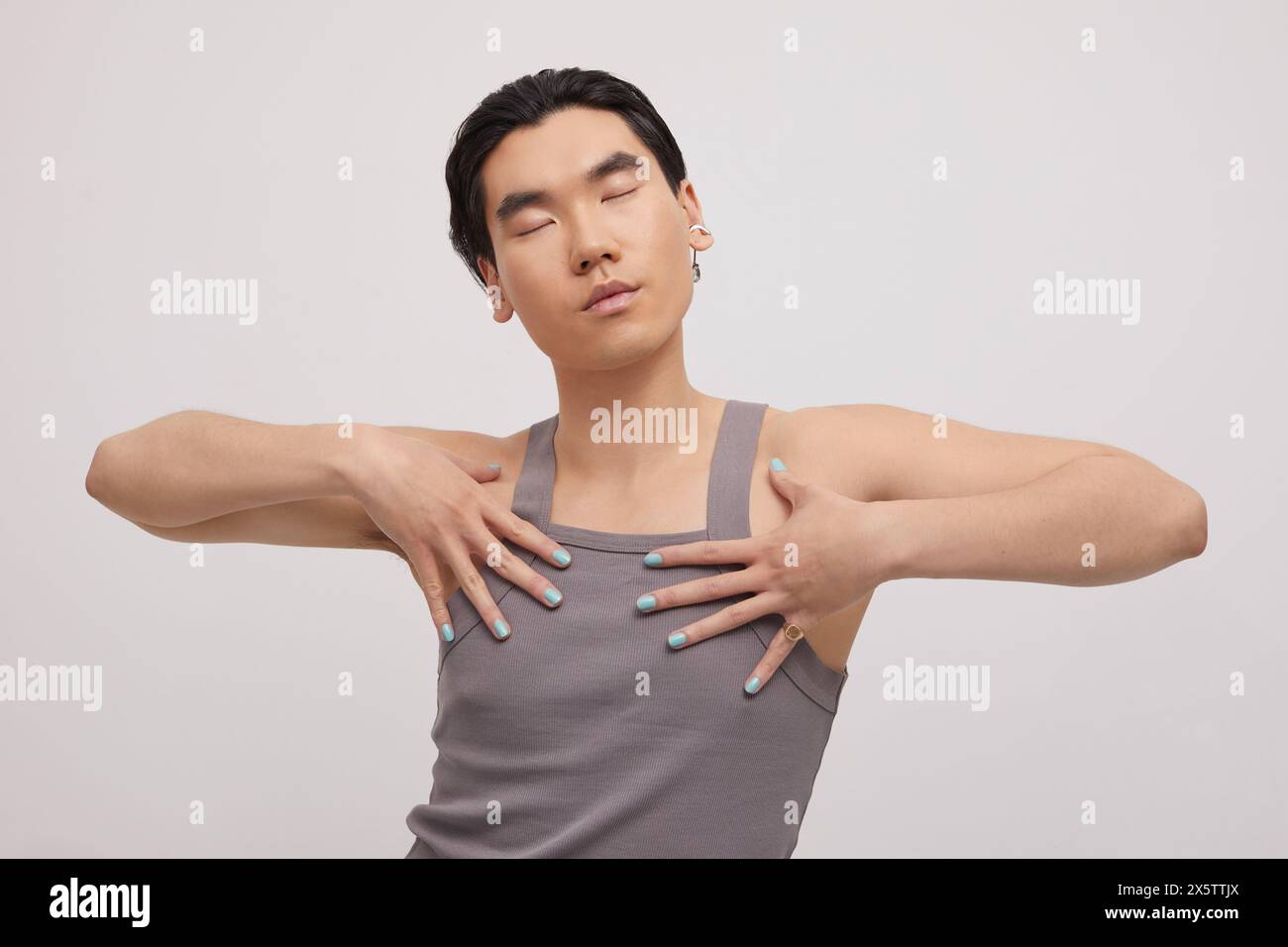 Studio portrait of handsome man with ear piercing Stock Photo