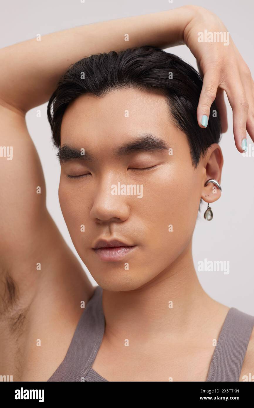 Studio portrait of handsome man with ear piercing Stock Photo