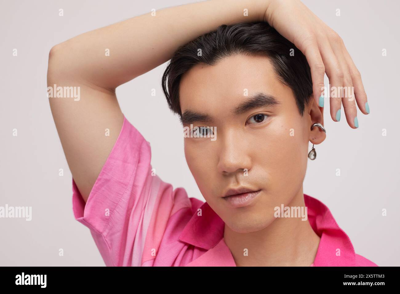 Studio portrait of handsome man with ear piercing Stock Photo