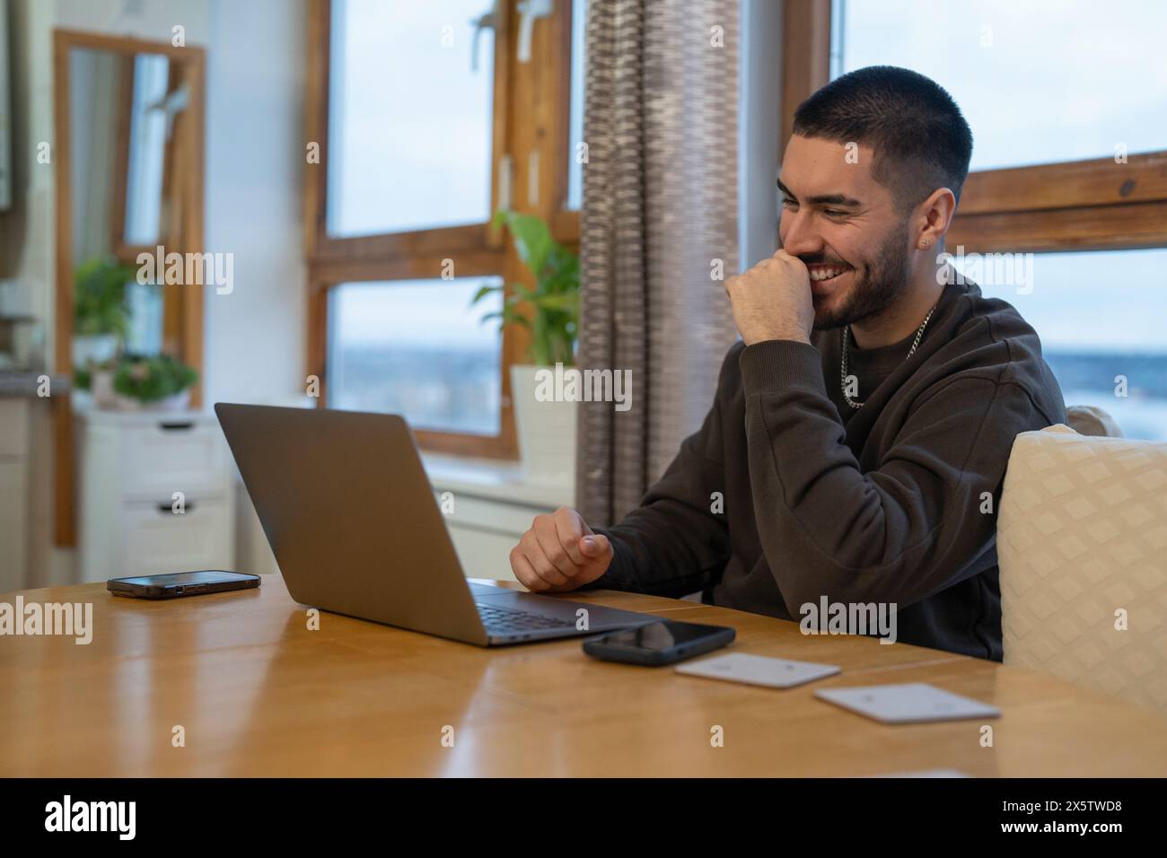Laughing black man using laptop hi-res stock photography and images - Alamy