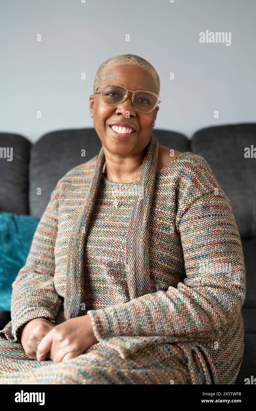 Mature woman sitting in living room Stock Photo - Alamy