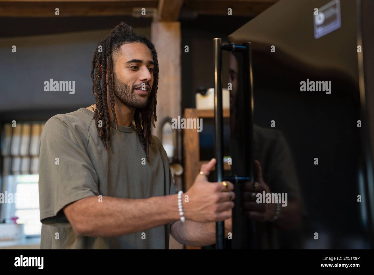 Man standing next to open fridge Stock Photo