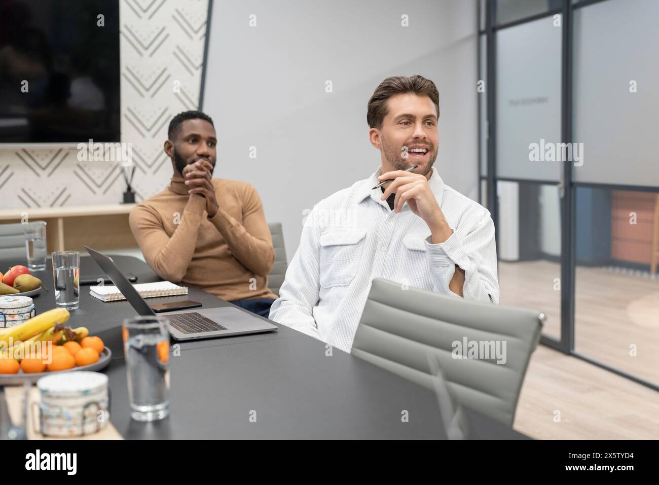 Businessmen having meeting in conference room Stock Photo