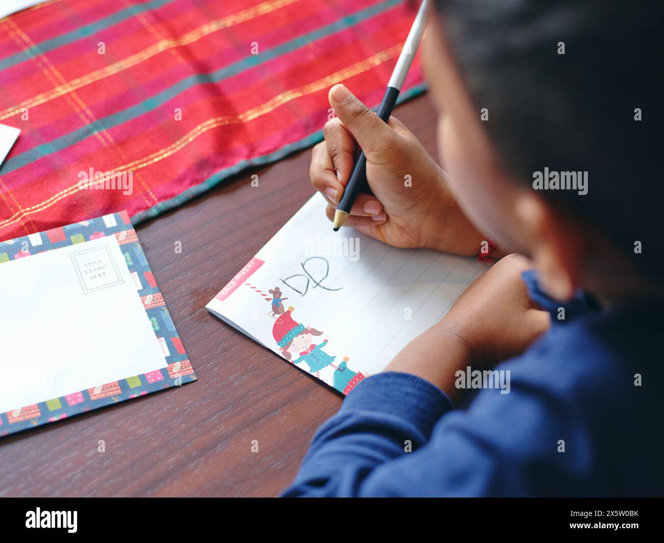 Boy writing letter to Santa Stock Photo