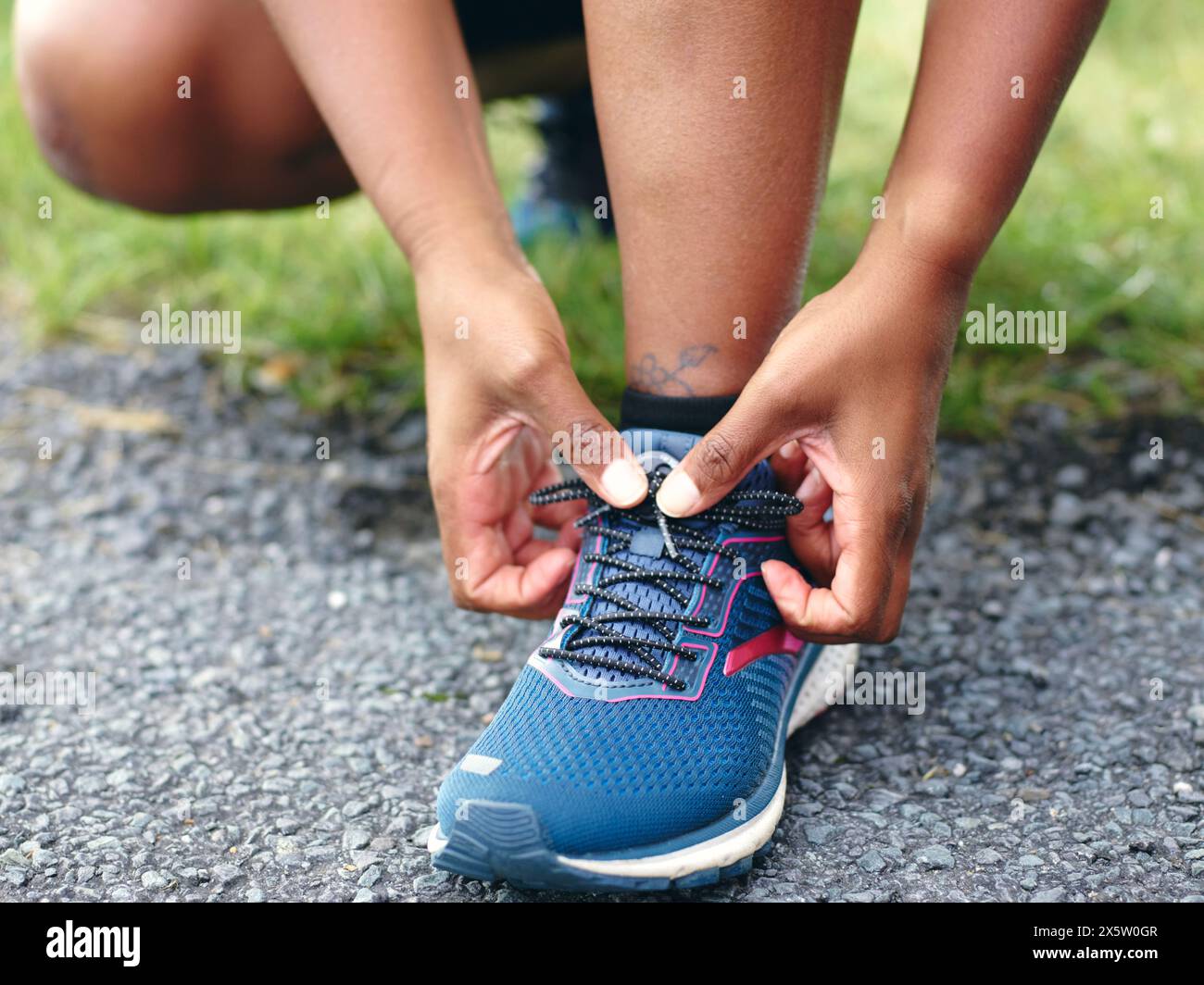 Woman tying running shoe laces Stock Photo