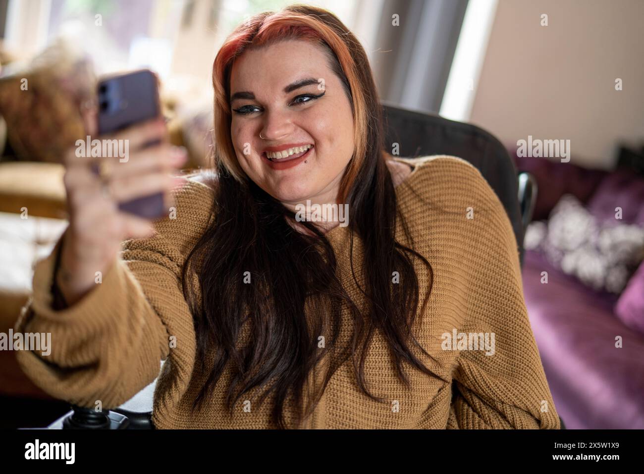 Woman in wheelchair taking selfie Stock Photo - Alamy