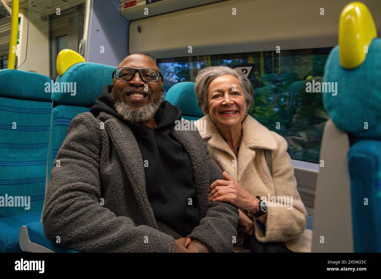 Portrait of senior couple on train Stock Photo