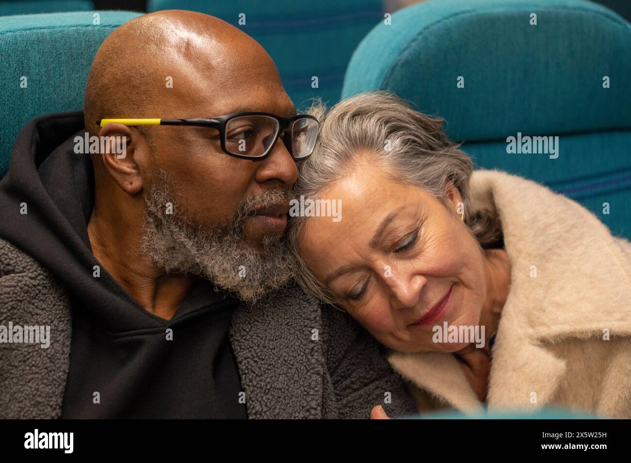 Senior couple napping on train Stock Photo