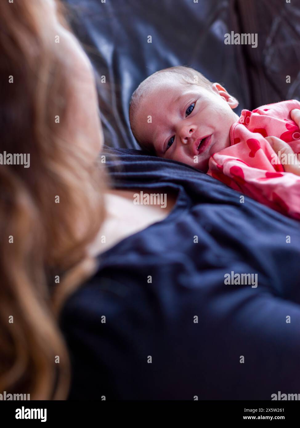 Daughter lying on her mother hi-res stock photography and images - Alamy
