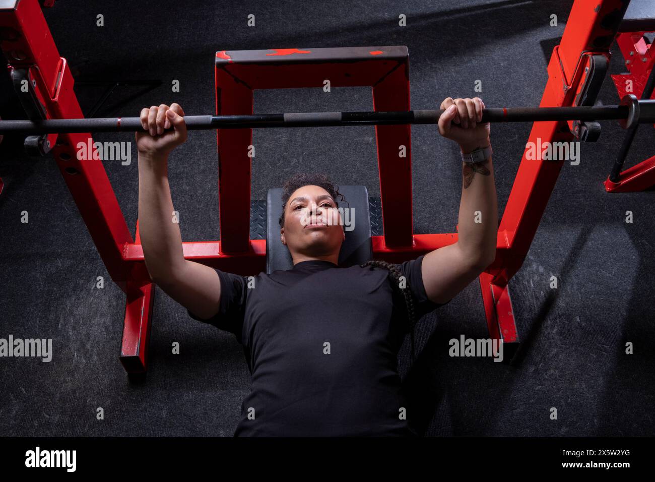 Overhead view of woman having bench press training in gym Stock Photo