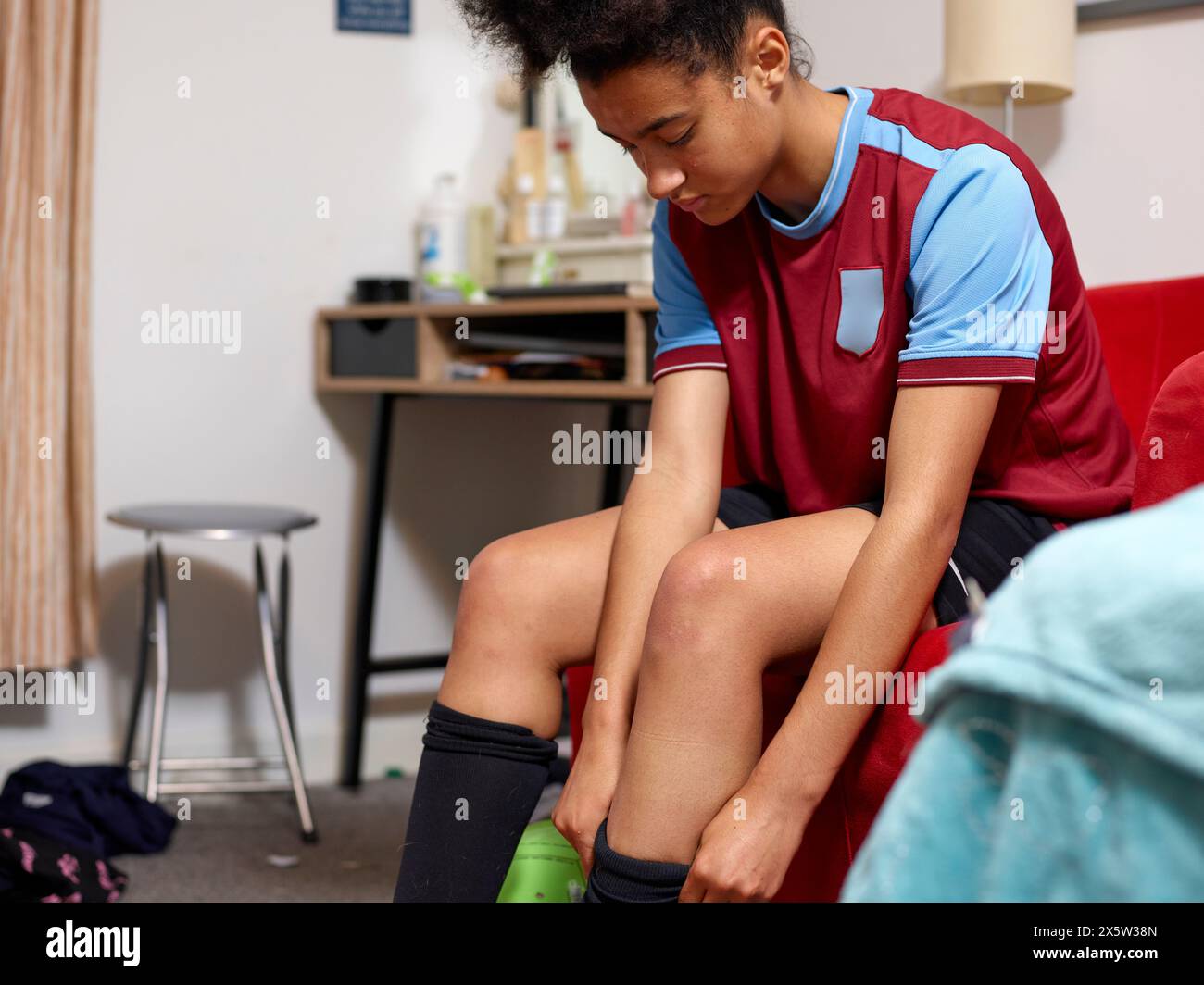 female-soccer-player-getting-dressed-in-bedroom-stock-photo-alamy