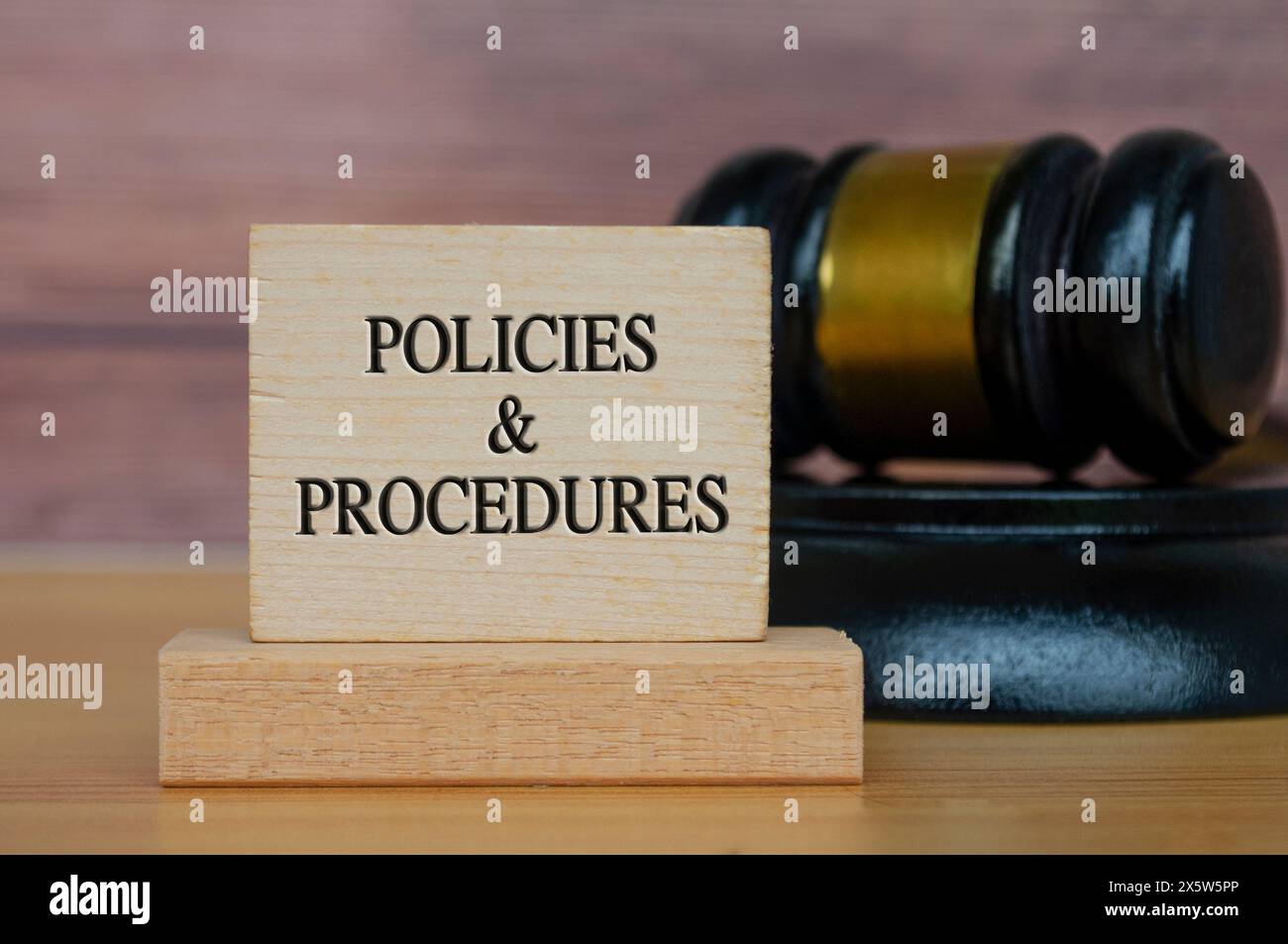 Policies and procedures text engraved on wooden block. Legal and law concept Stock Photo