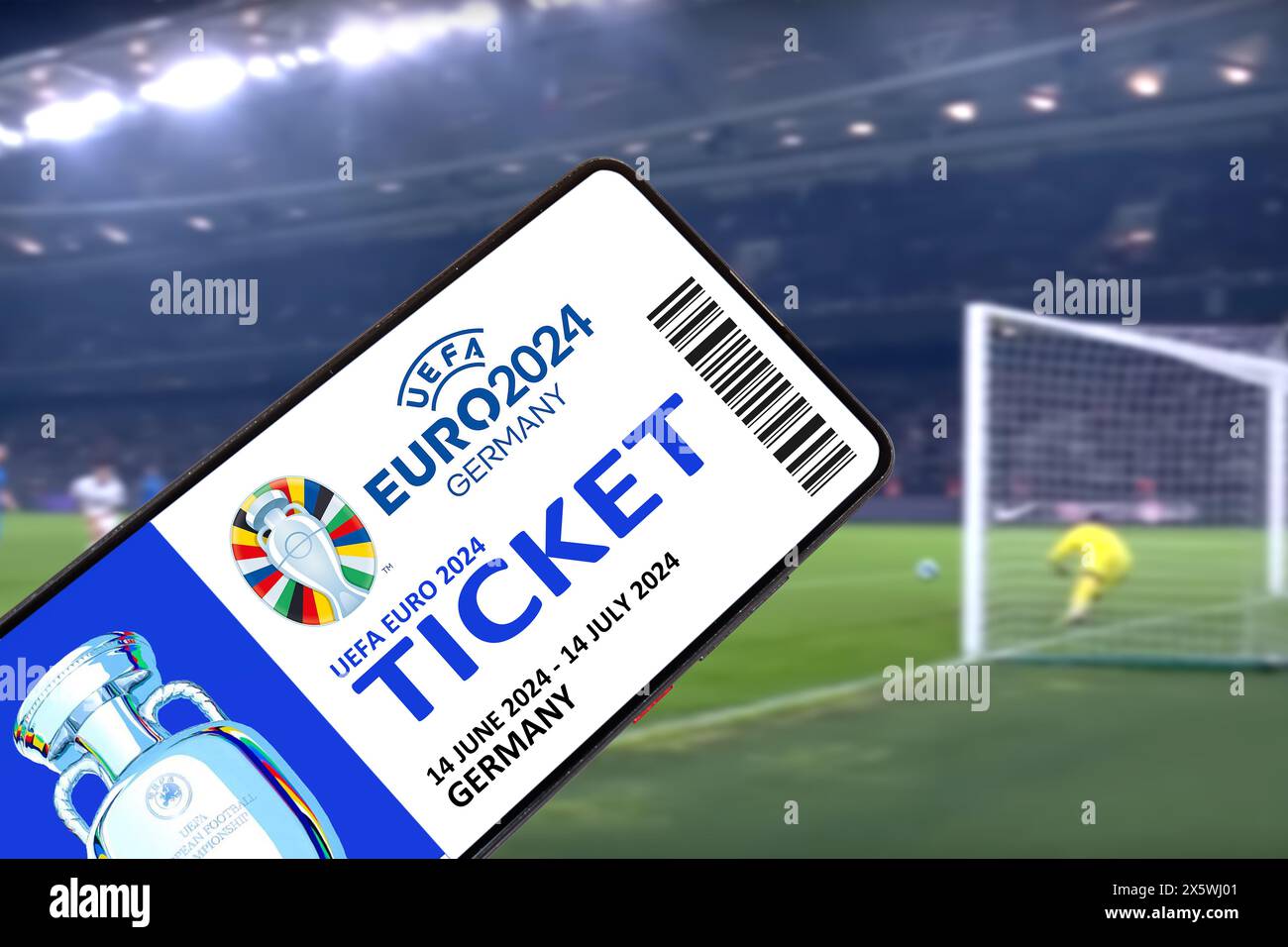 Germany - May 1, 2024: Ticket for UEFA Euro 2024 Germany European Football Championship Europe logo on a mobile in stadium photomontage in Germany. Stock Photo