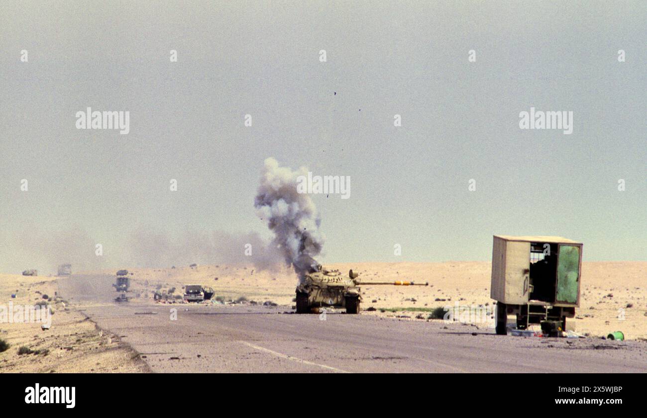 5th March 1991 An abandoned Iraqi T55 tank explodes, spewing smoke and shrapnel as it burns on Route 801, the road to Um Qasr, north of Kuwait City. Stock Photo