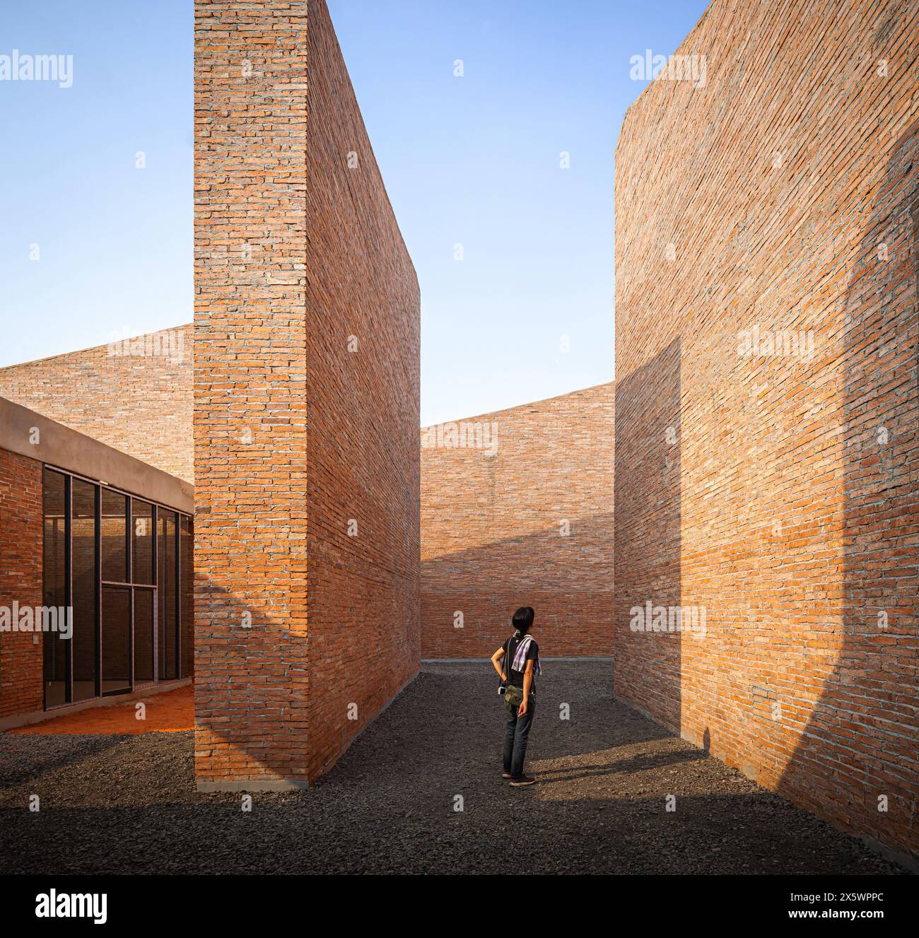 A woman considering in details of brick wall at the Elephant Museum in Thailand Stock Photo