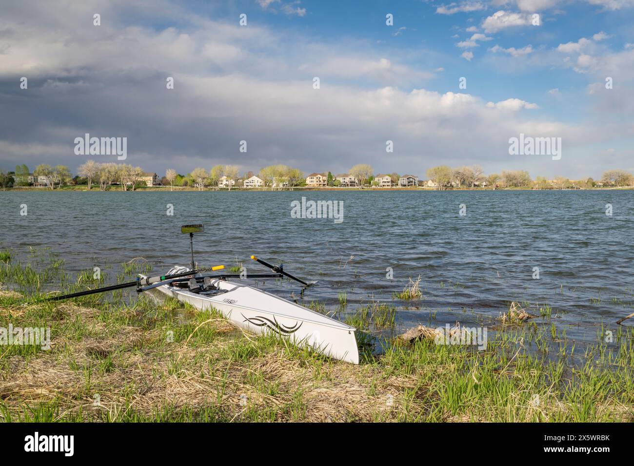 Loveland, CO, USA - May 2, 2024: Rowing shell by Liteboat on a grassy shore, Boyd Lake State Park in spring scenery. Stock Photo