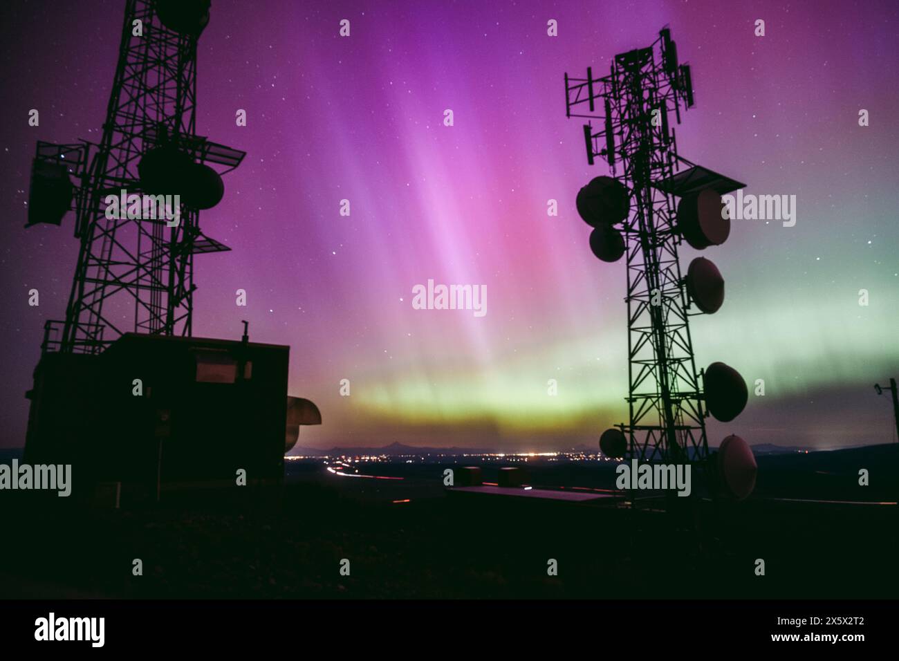 Communications towers above Bend, Oregon during Saturday morning's aurora. The National Oceanic and Atmospheric Administration Space Weather Prediction Center issued a rare warning about the solar outburst, because the bursts of energy hitting the earth could disrupt communications and power grids. Photo Will Hawkins/Ken Hawkins Pictures Stock Photo