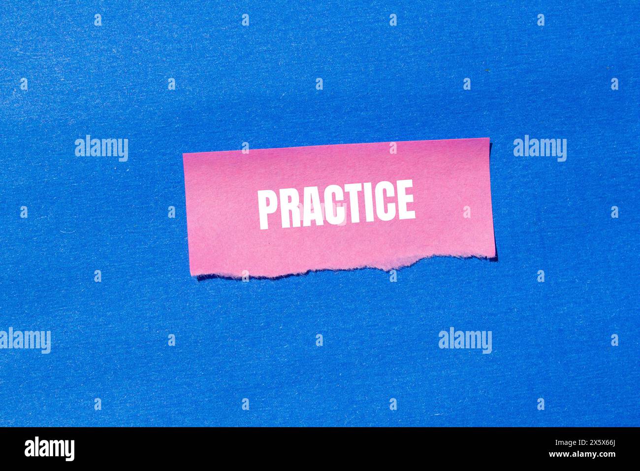 Practice word written on ripped pink paper with blue background ...