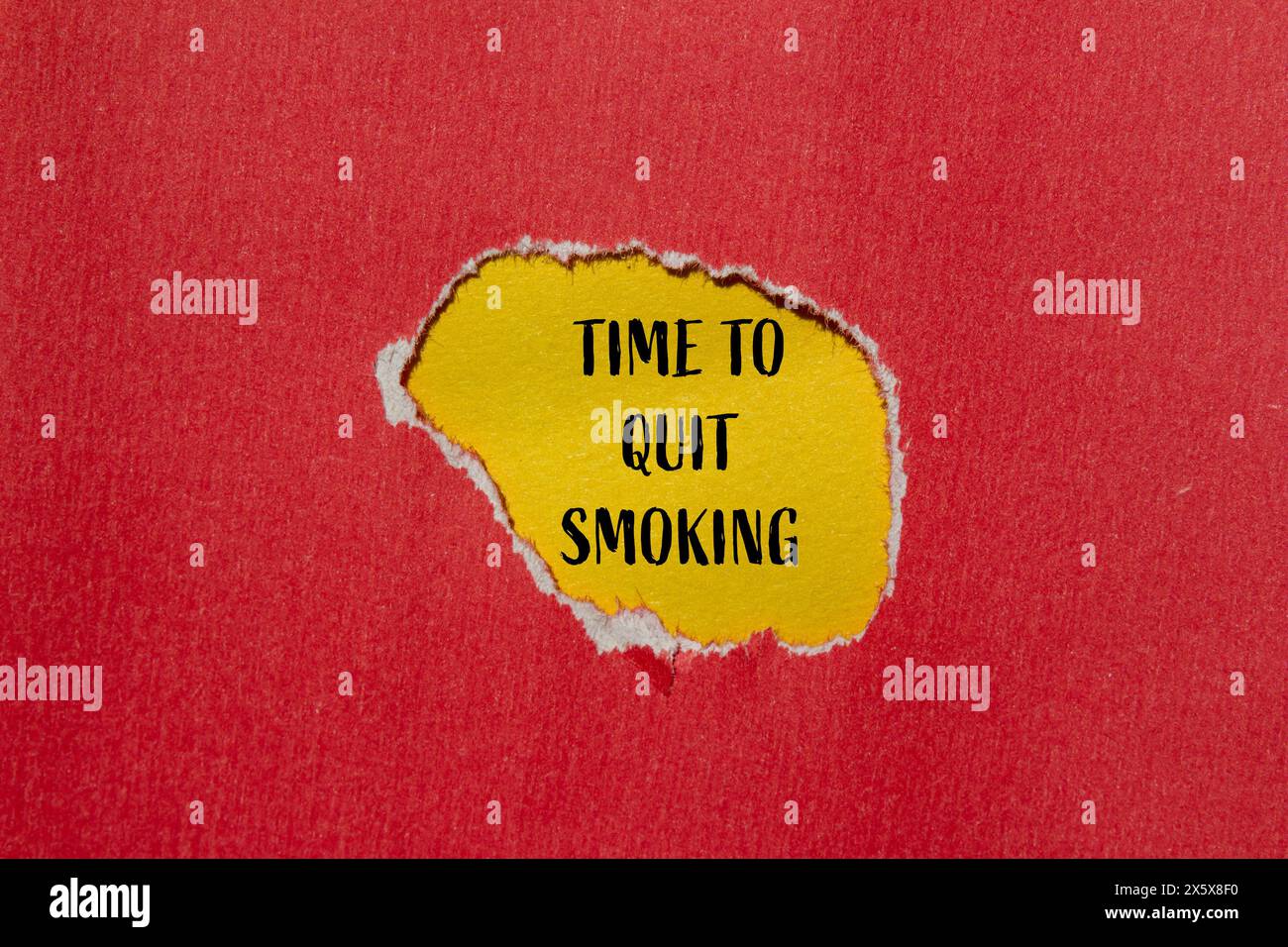 Time to quit smoking words written on ripped red paper with yellow background. Conceptual time to quit smoking symbol. Copy space. Stock Photo