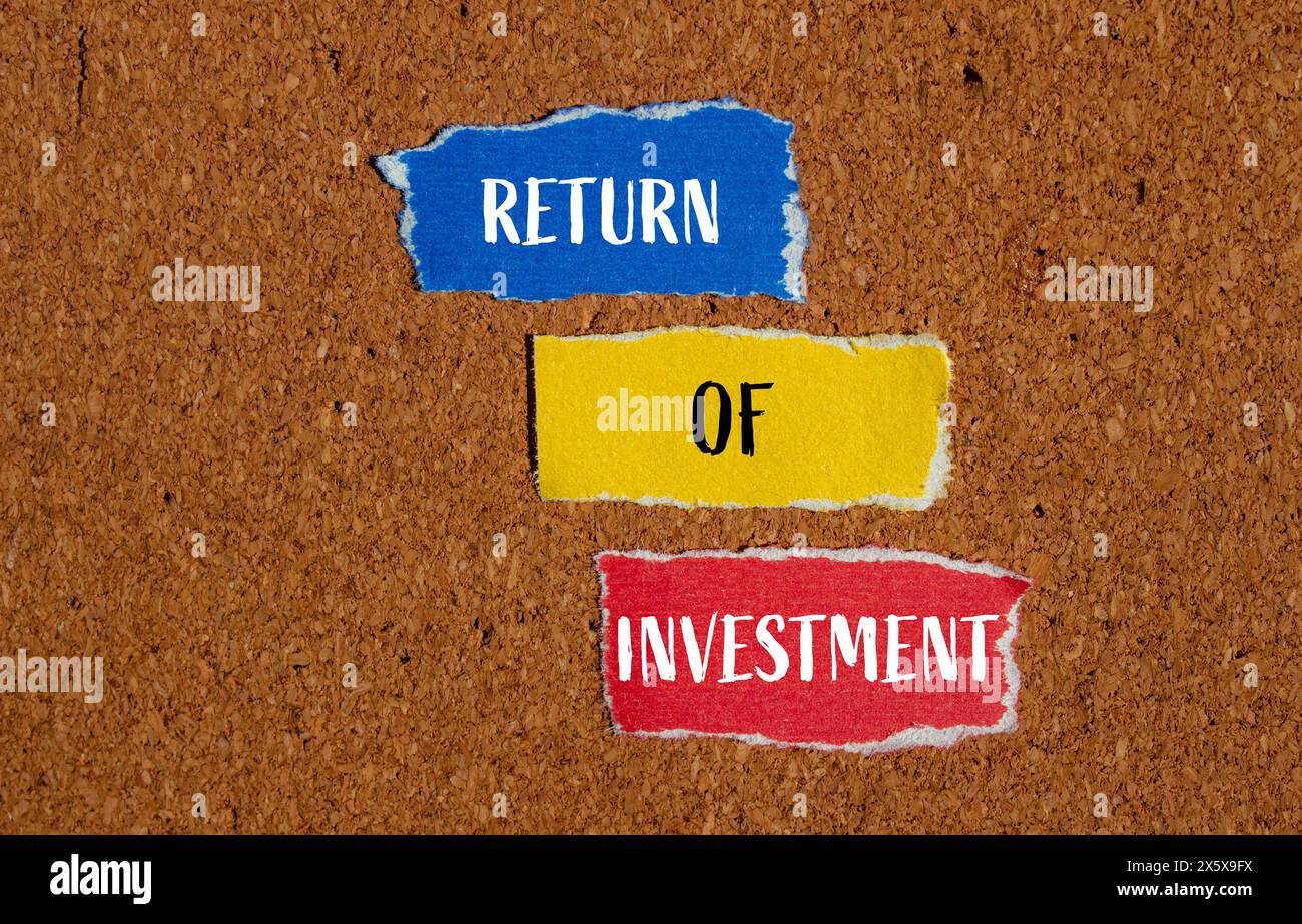 Return of investment words written on ripped paper pieces with brown background. Conceptual business return of investment symbol. Copy space. Stock Photo