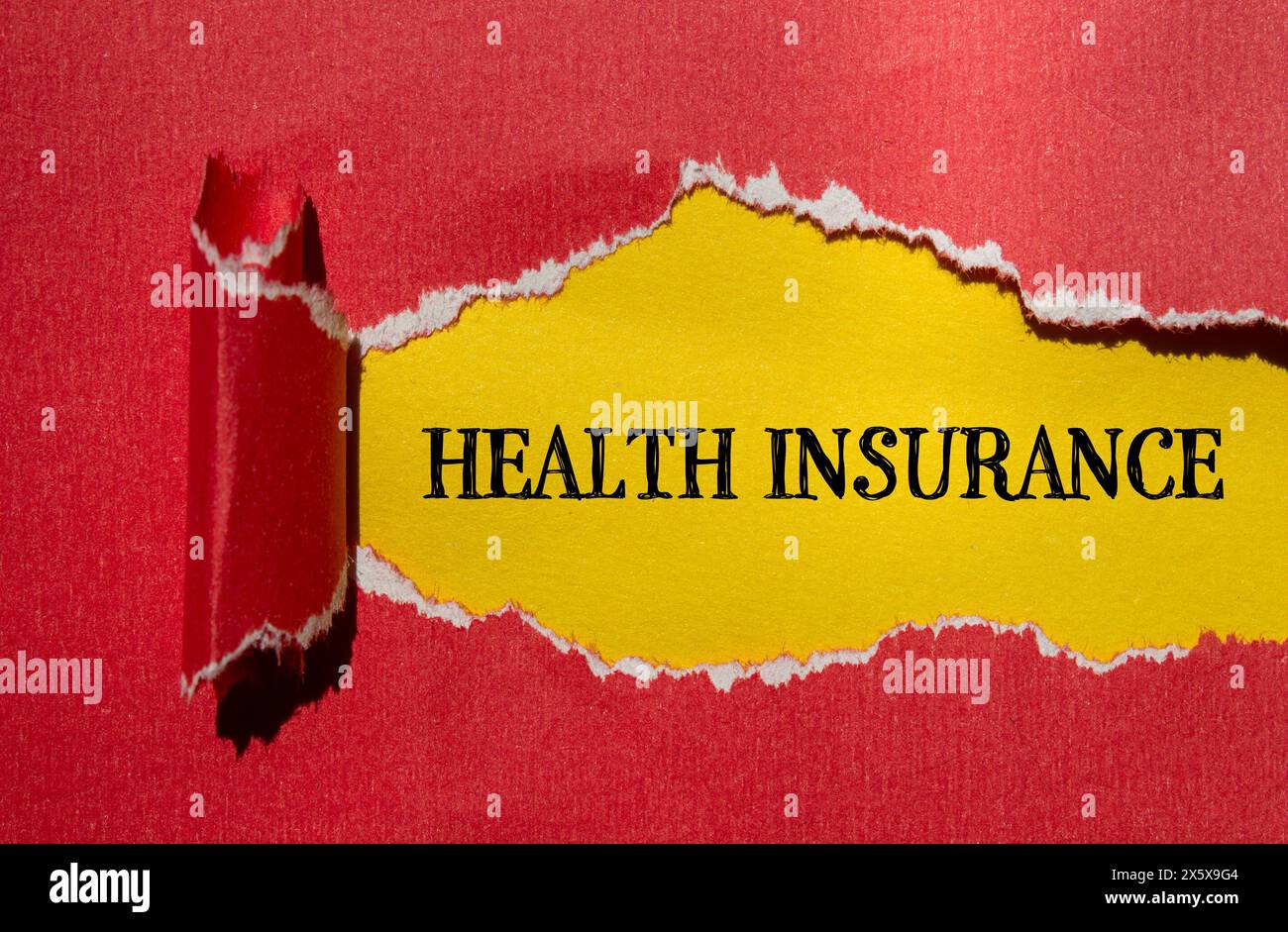 Health insurance words written on ripped red paper with yellow background. Conceptual health insurance concept. Copy space. Stock Photo