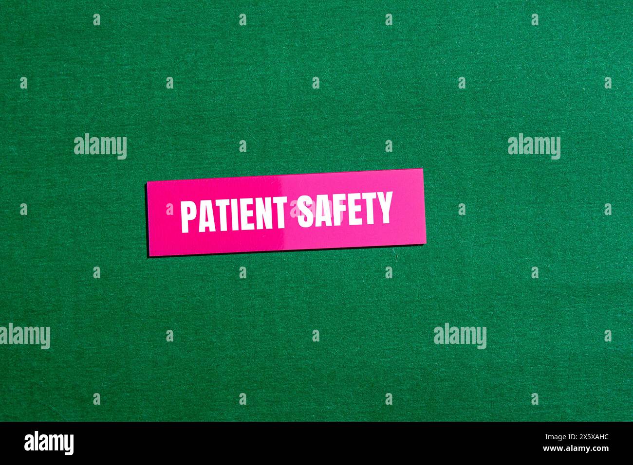 Patient safety words written on pink paper sticker with green background. Conceptual patient safety symbol. Copy space. Stock Photo