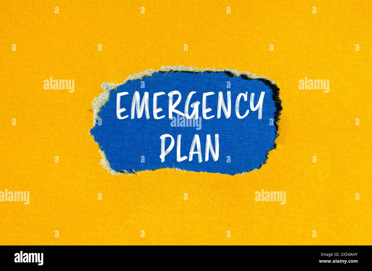 Emergency plan words written on ripped yellow paper with blue background. Conceptual emergency plan symbol. Copy space. Stock Photo