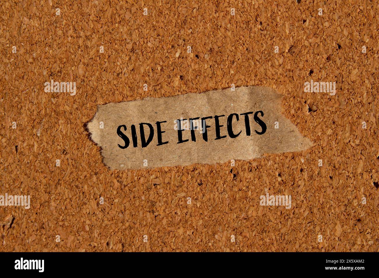 Side effects words written on ripped paper piece with brown background. Conceptual side effects symbol. Copy space. Stock Photo