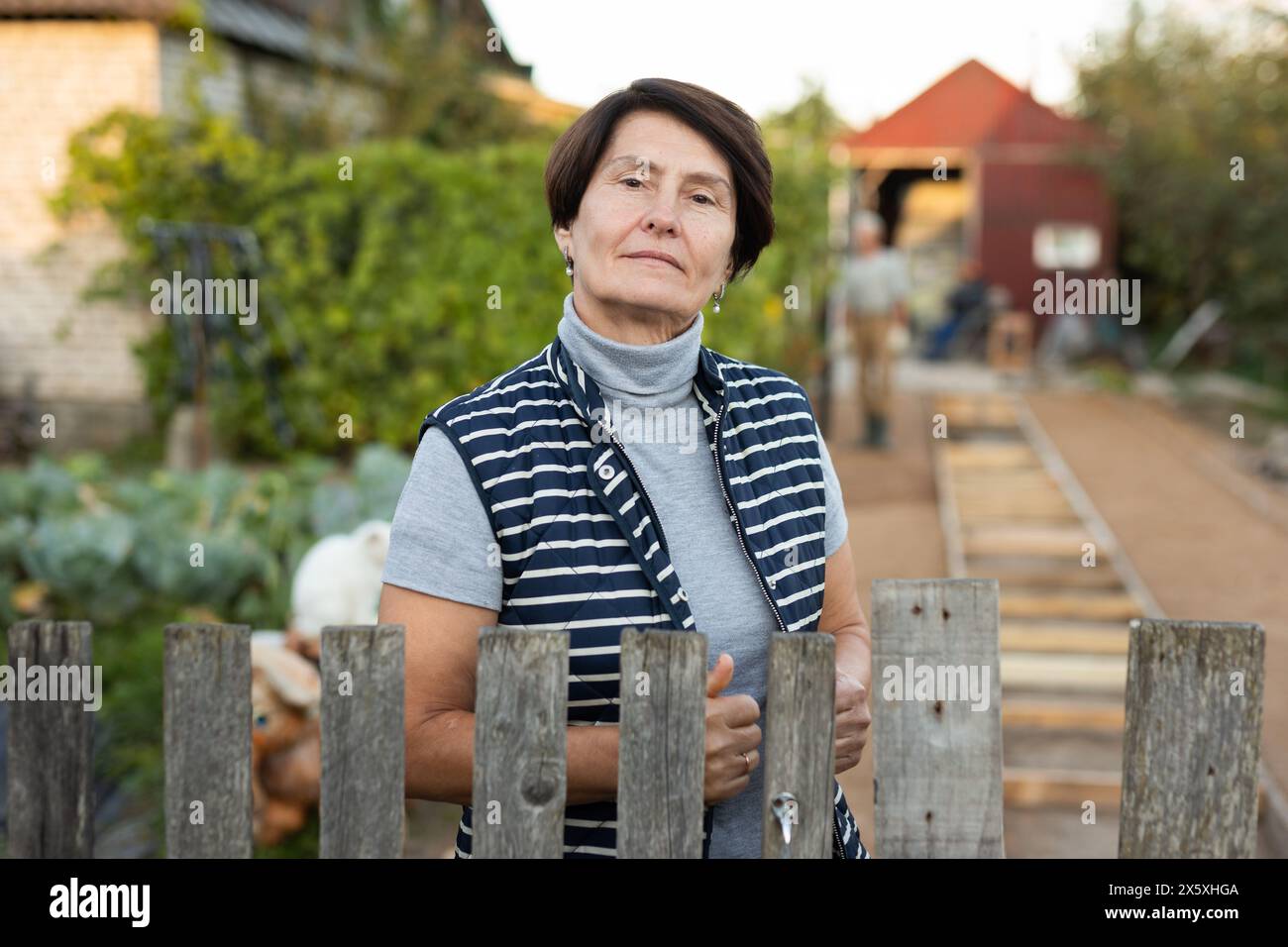 Elderly woman garden fence hi-res stock photography and images - Alamy