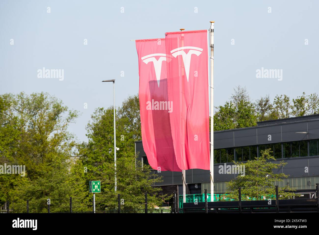 Tilburg, Netherlands. 01st May, 2024. An American automotive and energy company that specialises in electric car manufacturing; Tesla, flags seen in Tilburg. Tesla, has several factory buildings in the industrial zone of Vossenberg in Tilburg. Tilburg Factory & Delivery Center is next to the Wilhelmina Canal allowing for water-based delivery of intermodal. (Photo by Karol Serewis/SOPA Images/Sipa USA) Credit: Sipa USA/Alamy Live News Stock Photo