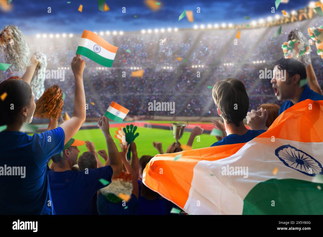 India sport supporter on stadium. Indian fans on cricket, rugby or football pitch watching team play. Group of supporters with flag Stock Photo