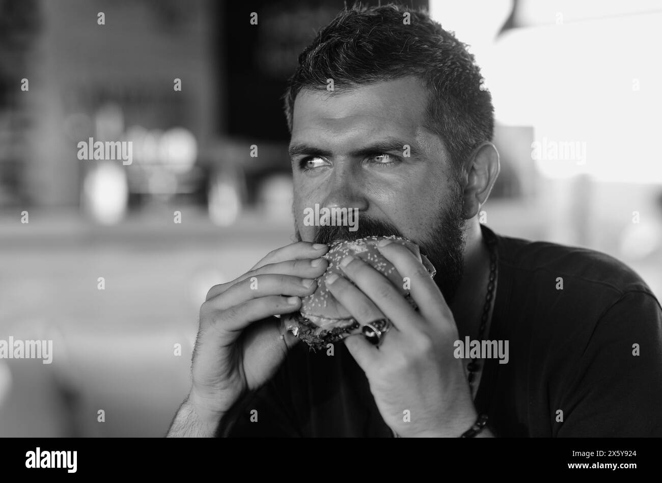 Hunger Man eat burger. Man eat tasty Hamburger. Dinner with Hamburger. Hamburger on lunch. Delicious gourmet. Cheeseburger or hamburger, burger Stock Photo