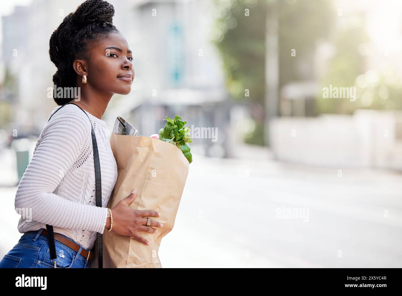 Bag, groceries and black woman for shopping, outside and vegetables for healthy food. Search, transport and travel with organic wellness produce Stock Photo