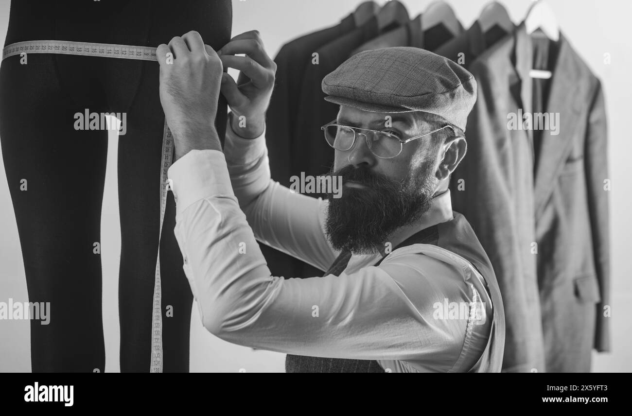 Sewing process. Male Dressmaker Sewing Female Clothing. Dressmaker