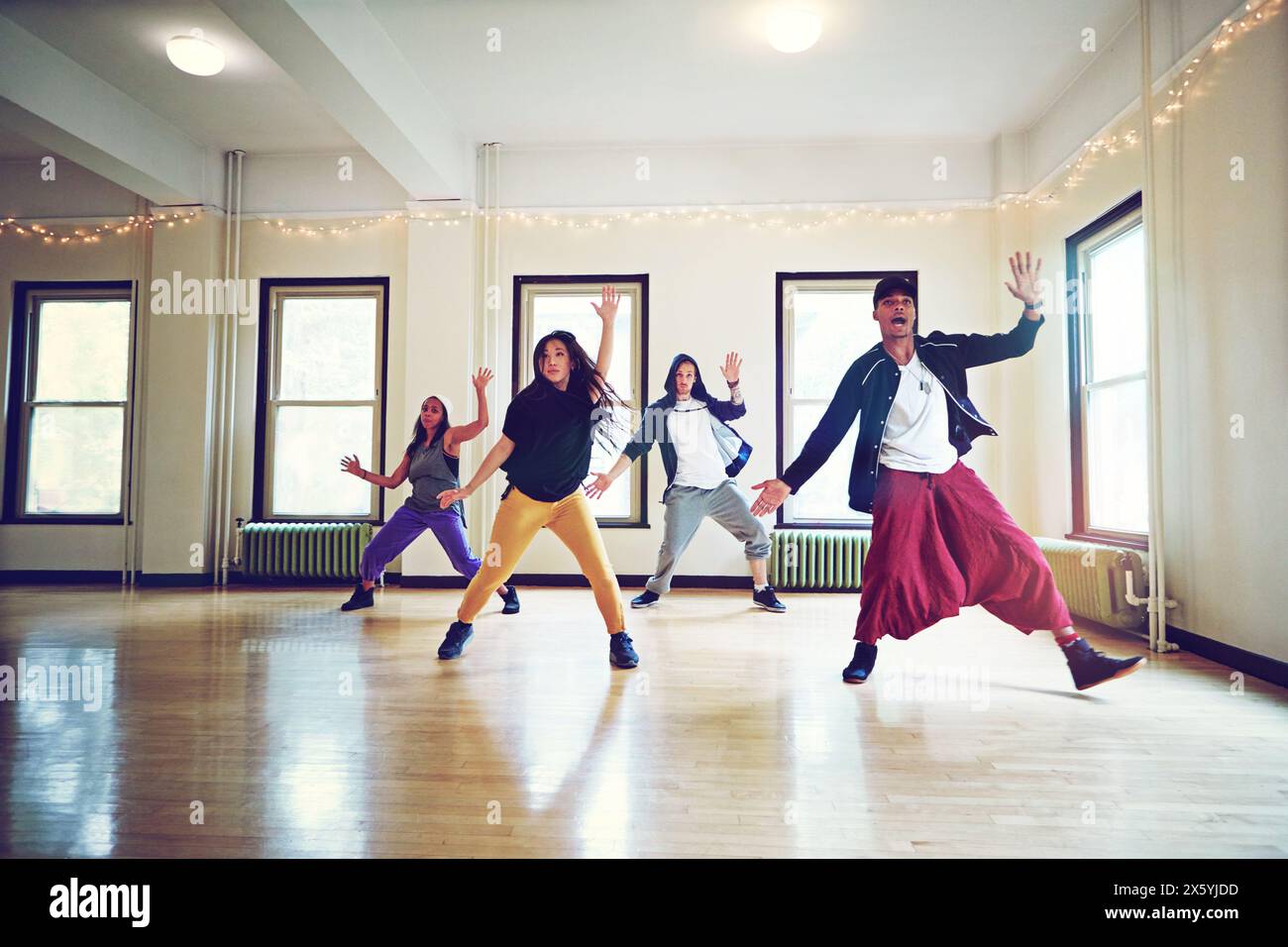 Indoor, hip hop and group of dancers for rehearsal, breakdance or action together for performance. Inside, practice or freestyle of talented people Stock Photo