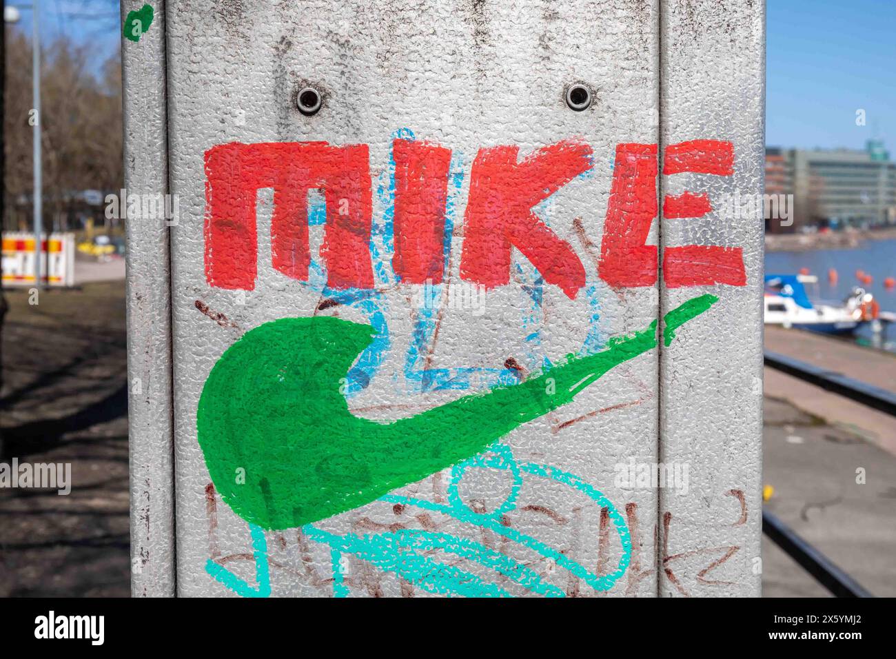 Mike resembling Nike logo painted on electric street cabinet in Merihaka district of Helsinki, Finland Stock Photo