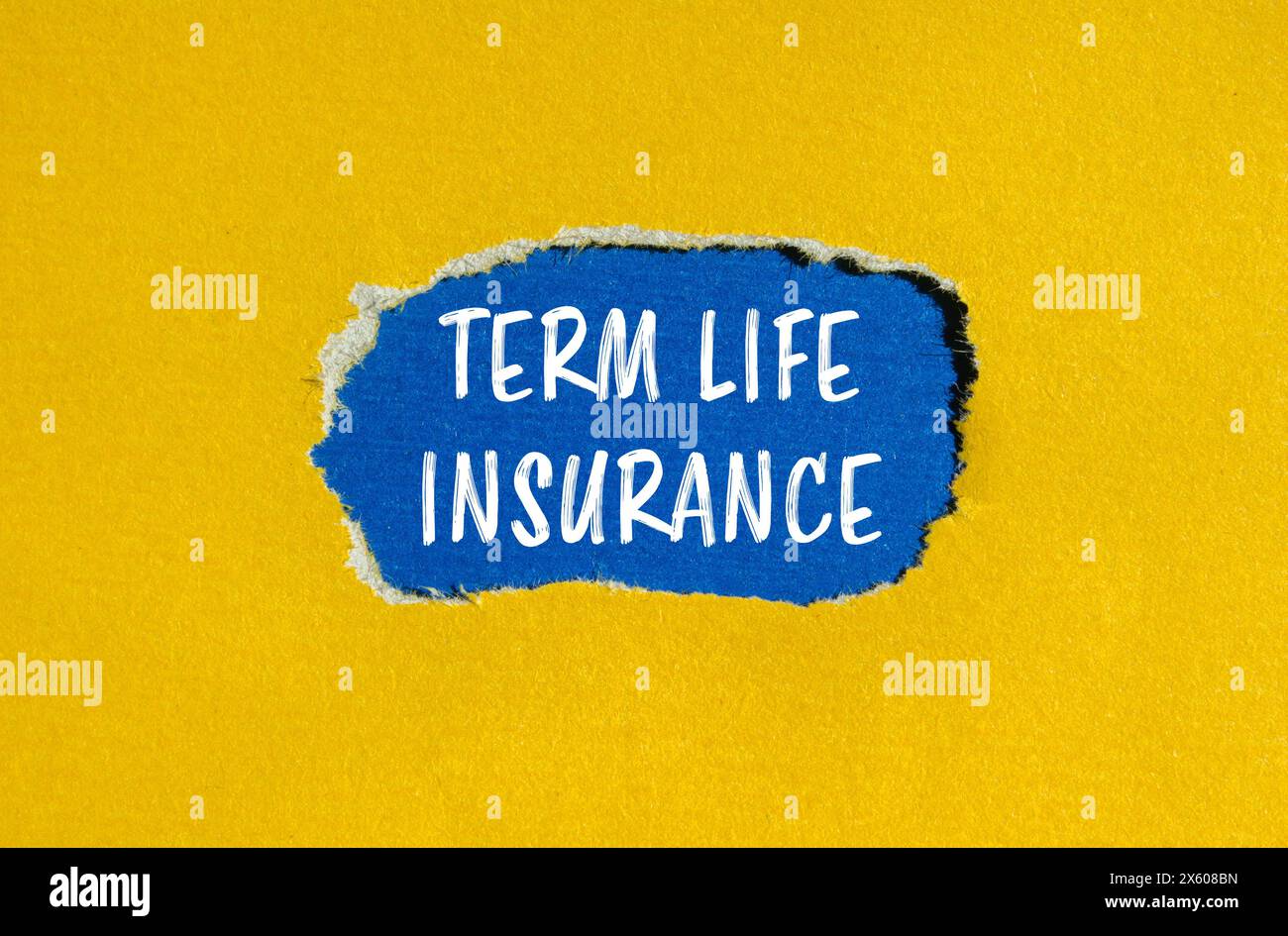 Term life insurance words written on ripped yellow paper with blue background. Conceptual term life insurance symbol. Copy space. Stock Photo