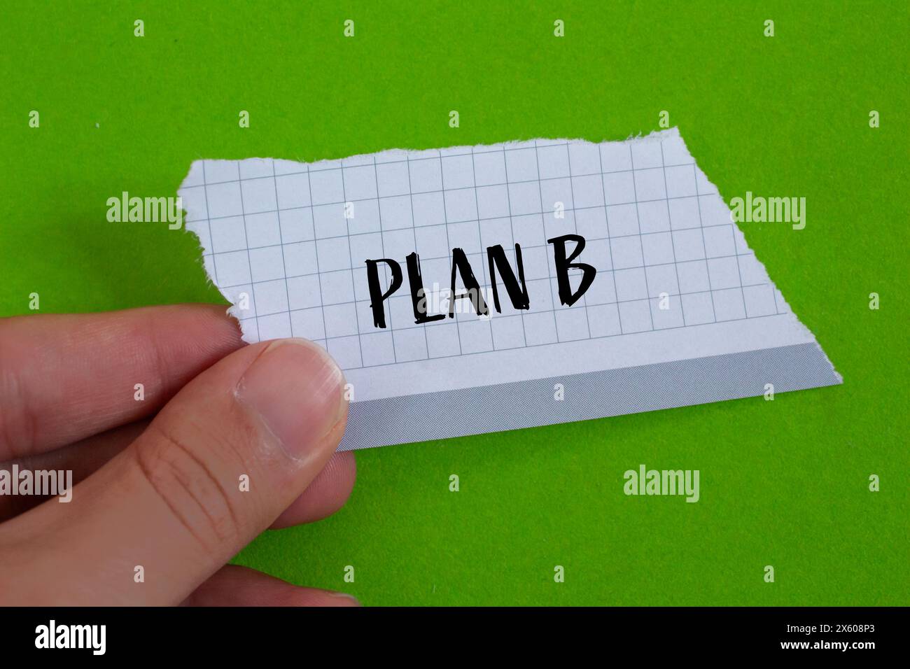 Plan b words written on ripped paper with green background. Conceptual