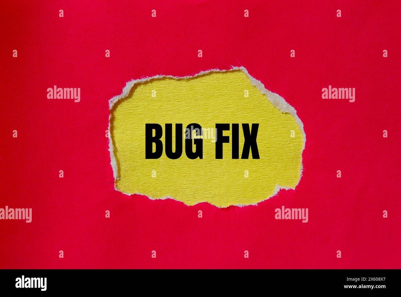 Bug fix words written on ripped red paper with yellow background ...