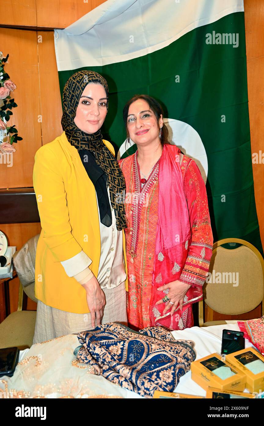 Kensington Town Hall, LONDON, ENGLAND, UK - MAY 11 2024: Pakistan stall at The Young Diplomats in London (YDL) are presenting a charity event called 'Weaving International Fashion - National Dress Catwalk'. representing over 17 embassies in the, each reflecting its unique cultural heritage. The Young Diplomats in London Fashion Show got it right. In this era of immigration, every culture is proud of the tradition represented by its own men and women. People should think twice before choosing to emigrate. As an immigrant, we have given up our status and birthrights, but they have maintained the Stock Photo