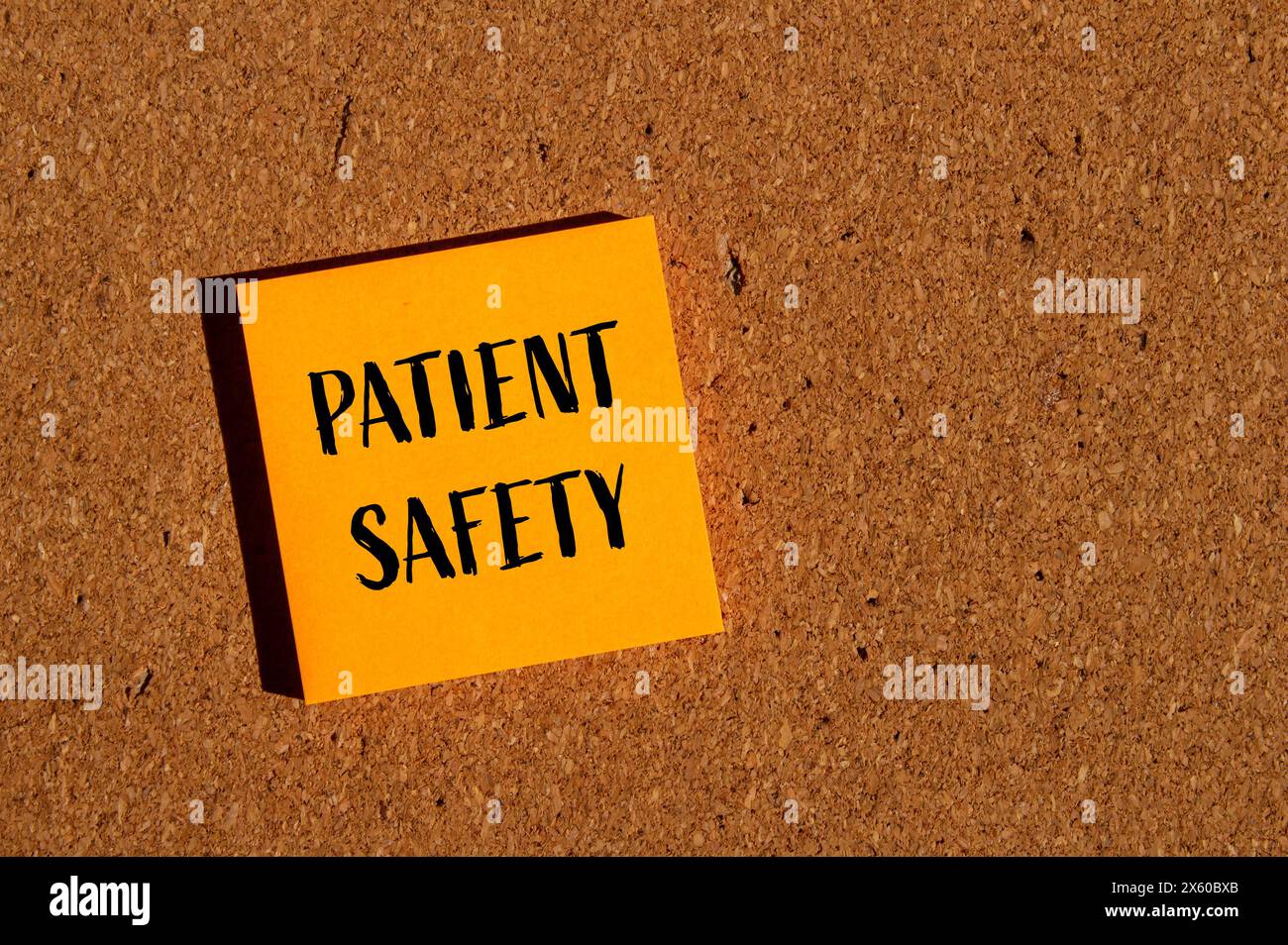 Patient safety words written on orange paper sticker with brown background. Conceptual patient safety symbol. Copy space. Stock Photo