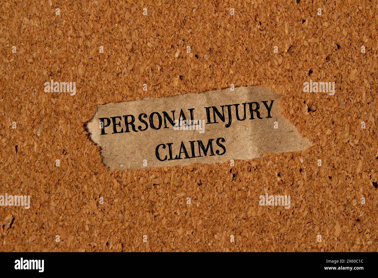 Personal injury claims words written on ripped paper piece with brown background. Conceptual personal injury claims symbol. Copy space. Stock Photo